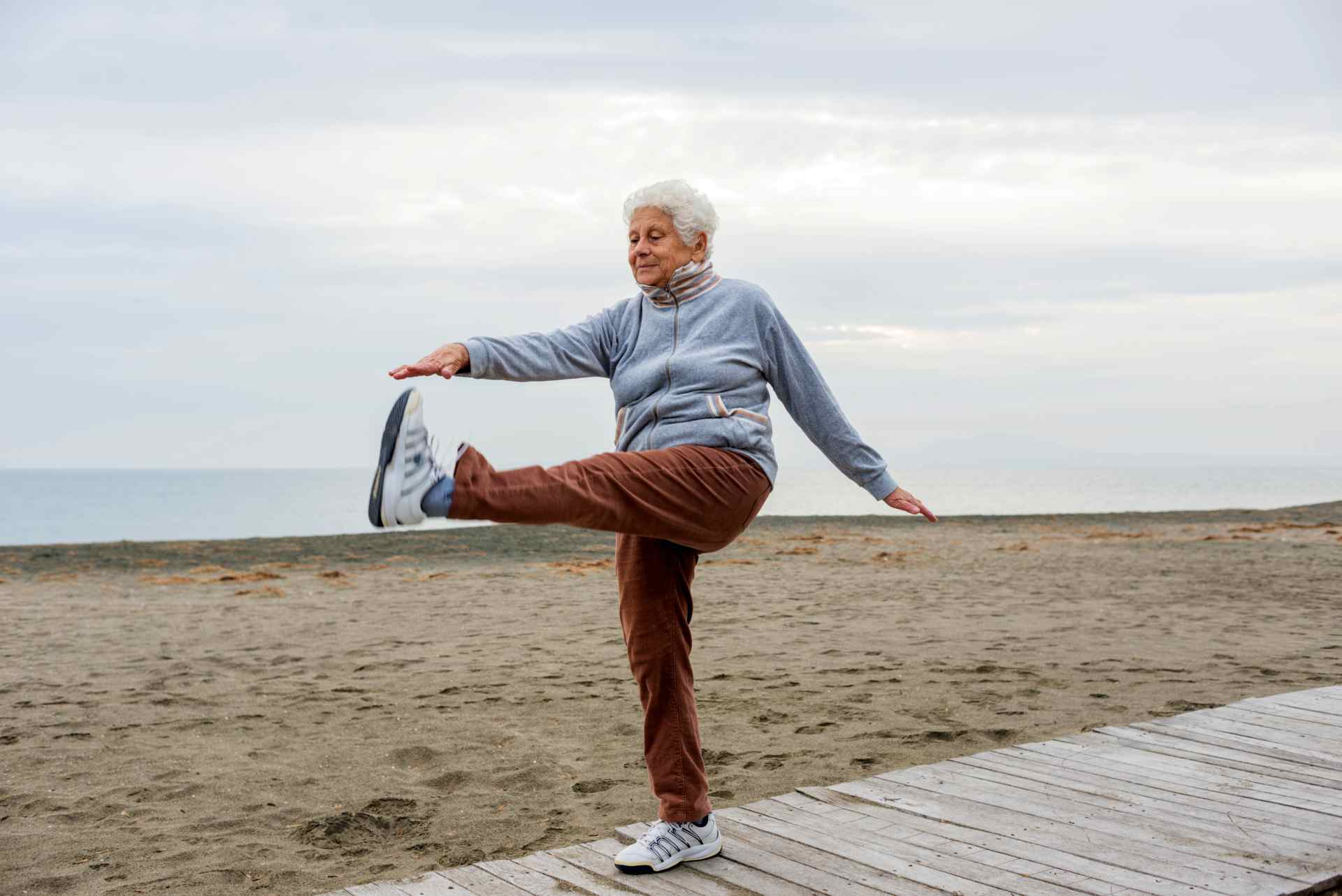 Senior woman morning arm and leg stretch